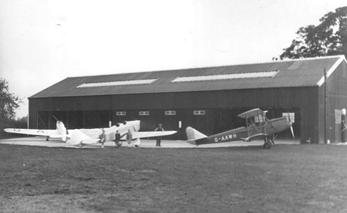 The completed second hangar with resident and visiting aircraft in front.