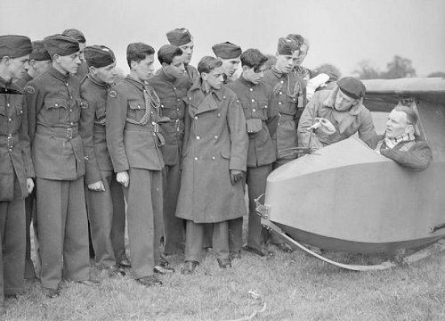 Cadets of the Air Training Corps receive instruction from Flight Lieutenant S C C Taylor, seated in the glider, at 125 Gliding School, Denham, 1945.