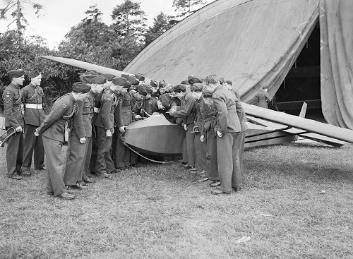 Cadets of the Air Training Corps with one of 125 Gliding Schools' Cadet TX.1 gliders outside one of the canvas fronted blister hangars at Denham in 1945. The buildings and aircraft soon began to suffer at the hands of vandals after the RAF left.