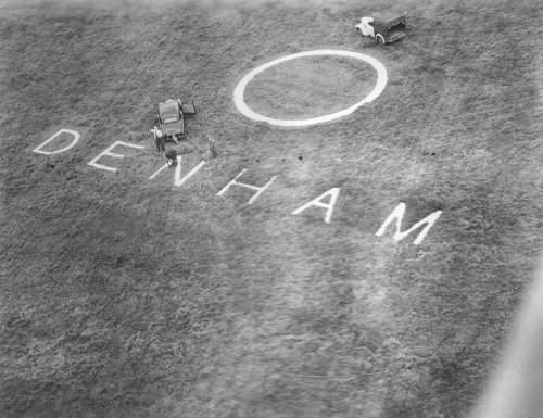 The aerodrome name and symbol was laid in concrete on the airfield and needed periodic trimming to keep it visible, as seen here.