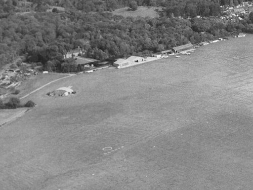 The caravans, one of which can be seen in this view, were positioned against the hedge on the triangular section of land near the blister hangar.