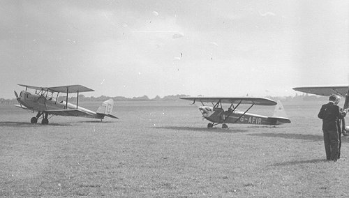 Demonstrations in front of the BBC team included a six man parachute team, seen here landing behind the Denham based Spartan Arrow and a visiting Luton LA4 Minor.