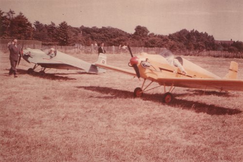 Two of the Tiger Club's Druine D.31 Turbulents at Denham in 1958 during a fly-in, G-APBZ furthest from the camera. David Ogilvy and Scott Hill are seen admiring the aircraft.
