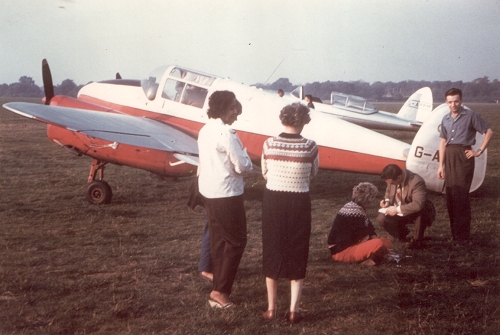 Miles Gemini G-AKEM with owner Marian Driessen and Eva Bickerton watching Ron Atkinson signing Beatrice Bickerton's log book.