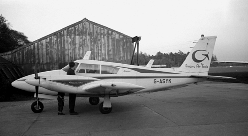 Gregory Air Taxis Twin Comanche G-ASYK seen parked between the north side hangars.