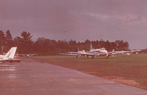 Two of the three de Havilland dH.104 Doves purchased by Ken Gregory in October. On the left of the picture is the tail of G-ASMR, one of the new Piper PA-28 Cherokees at the Gregory School of Flying.