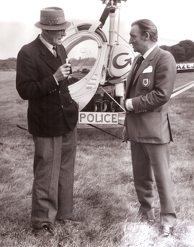 Aerodrome founder and owner Myles Bickerton with ..., discussing the concept of the police use of helicopters at the Denham exhibition flights held in 1973.