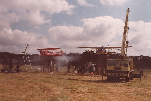Brian Lecomber's Stampe, seen here mounted on a plinth next to a Cessna 150 during filming at Denham in June 1978.