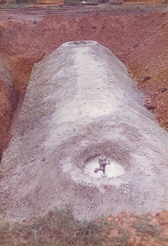 The fully enclosed tank, ready to be connected to the pump and filling systems. The concrete jacket served as protection for the tank.