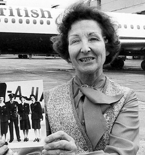 Joan Crane in front of a British Airways Trident at Heathrow with a picture of her first crew and their Douglas DC-3 Dakota.