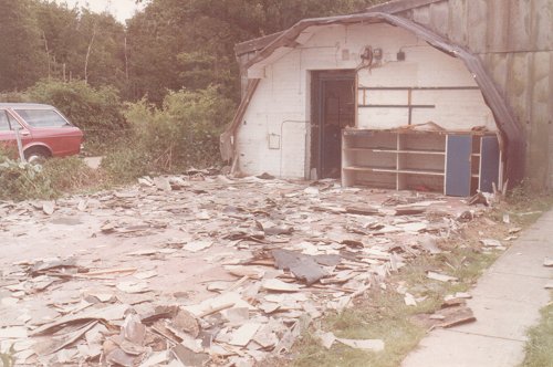 The old Nissen hut demolition nearing completion, the characteristic arched shape is clearly visible in the remaining end wall.