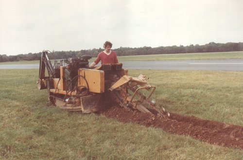 The unusual digger cut a deep furrow in the grass to take the power and control cables for the new threshold lights.