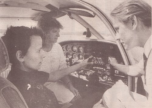 Fundraiser Sue Ayris, Daniel Osbourne and instructor Meg Crawford go over the controls of the Piper Cherokee.