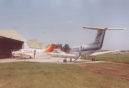United Biscuits required the use of another King Air for their annual board meeting in 1989, the chartered aircraft is seen here with one of their fleet. The hardened taxiway track can just be made out behind the aircraft.