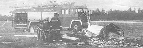 The remains of the BBC Flying Club's Slingsby T.67 Firefly being examined by the local fire brigade.
