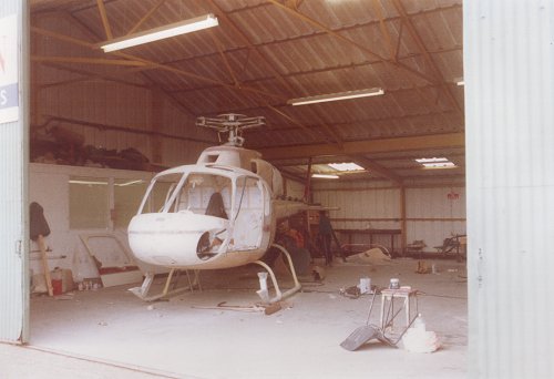 The spray bake paint facility in the end of Hangar J with a Squirrel helicopter being repainted.