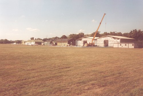 An unusual view along the front of the hangars in 1989, with the Hangar I extension beginning construction.